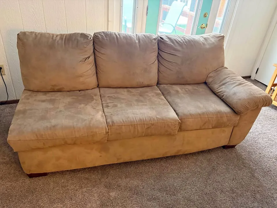 A sofa being removed from a home